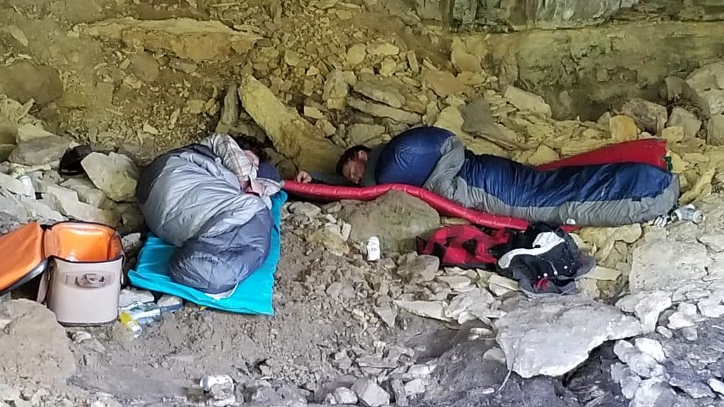 We had heavy rain on a river trip and camped in a cave. Not so comfortable for sleeping but a river pad and a few too many beers helped these guys sleep through the night.